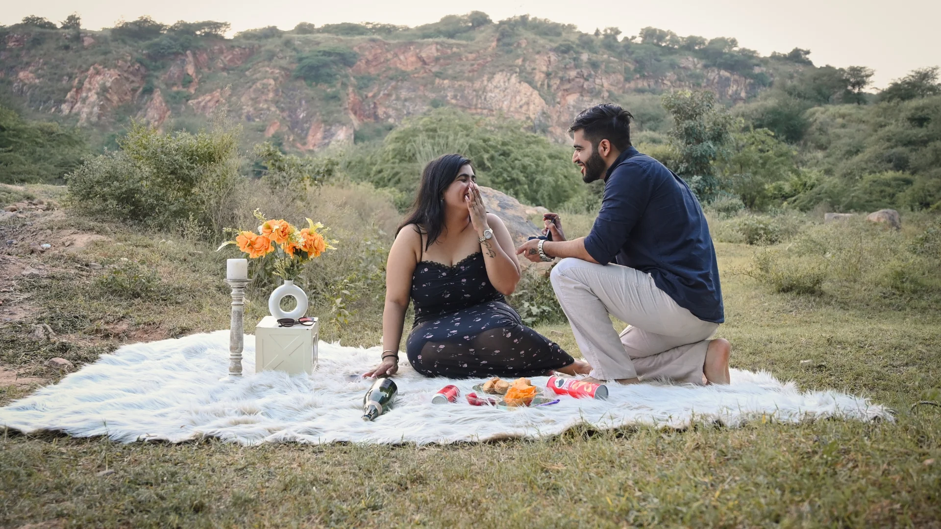 Couple enjoying a surprise proposal during a romantic pre wedding shoot by Indo Frames in Gurgaon.